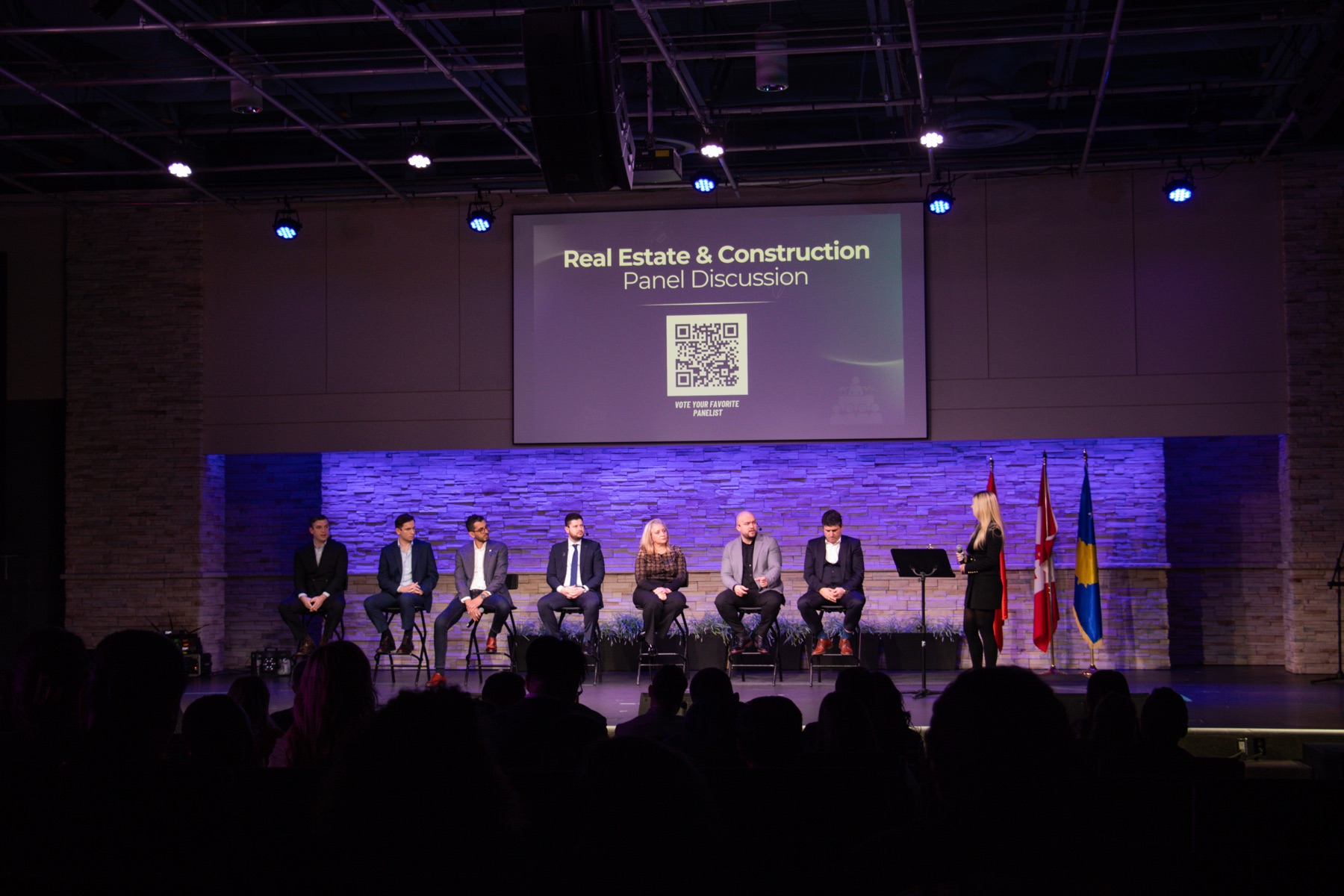 Speakers in conversation onstage during an industry event organized by the team